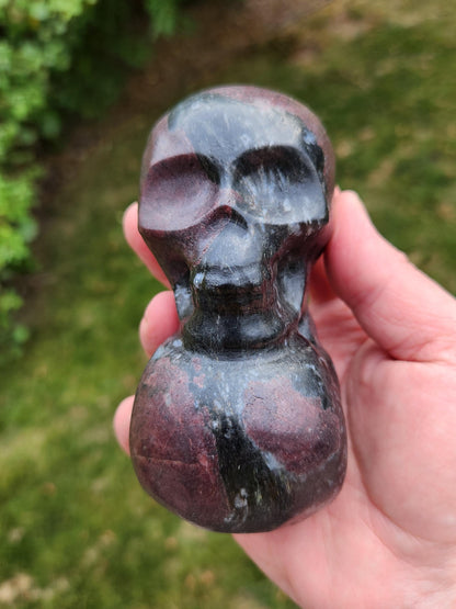 Double Skull in Garnet with Fireworks or Arfvedsonite Crystal Carving