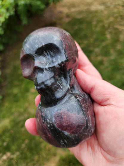 Double Skull in Garnet with Fireworks or Arfvedsonite Crystal Carving