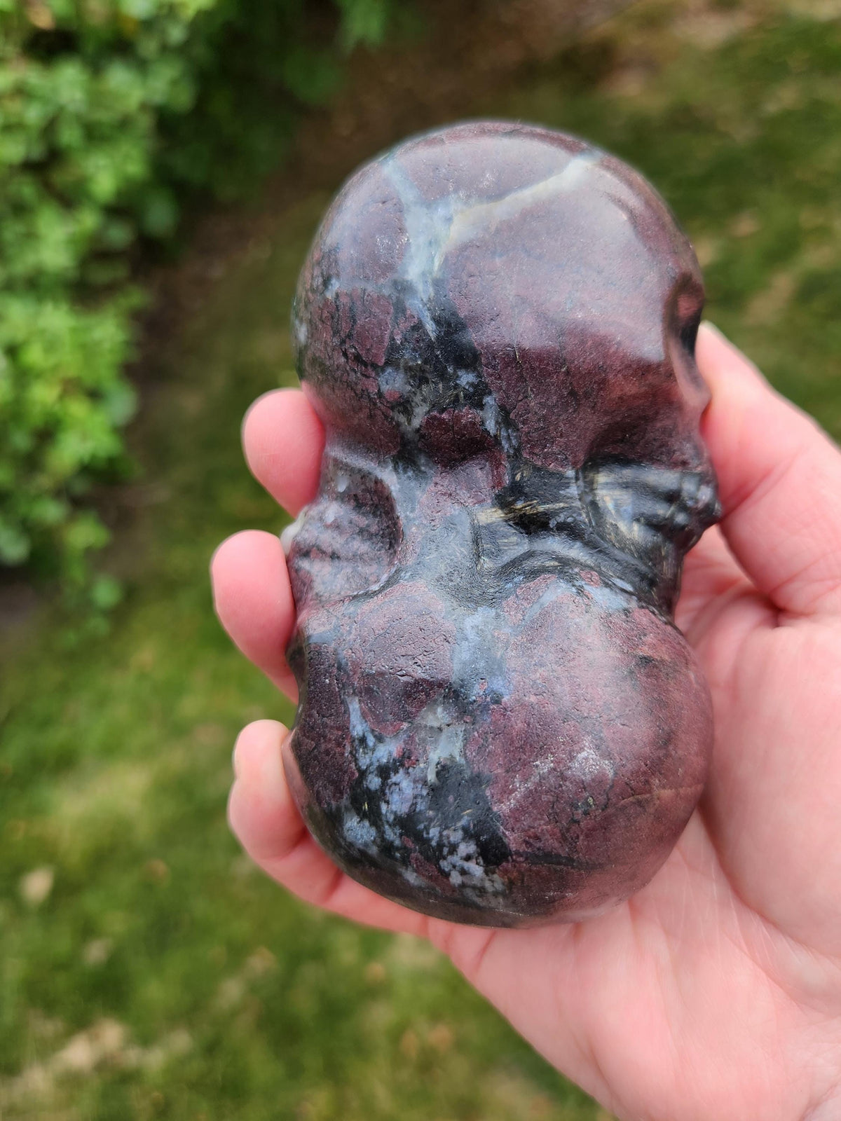 Double Skull in Garnet with Fireworks or Arfvedsonite Crystal Carving