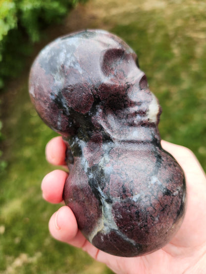 Double Skull in Garnet with Fireworks or Arfvedsonite Crystal Carving