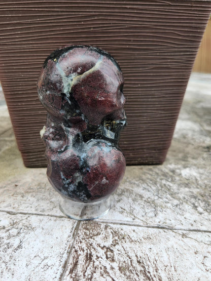 Double Skull in Garnet with Fireworks or Arfvedsonite Crystal Carving