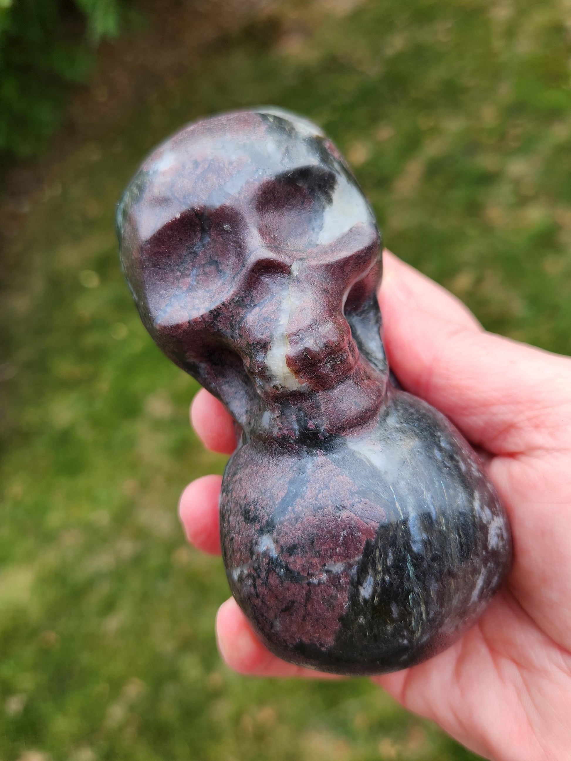 Double Skull in Garnet with Fireworks or Arfvedsonite Crystal Carving