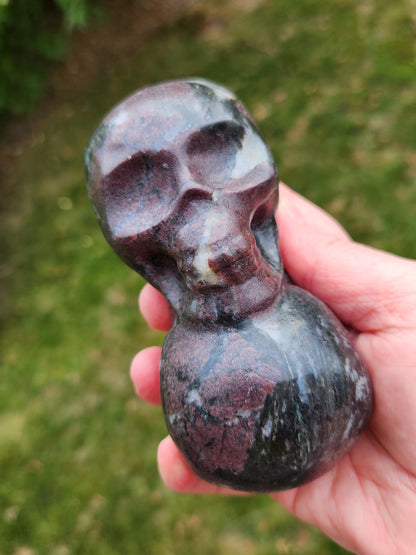 Double Skull in Garnet with Fireworks or Arfvedsonite Crystal Carving