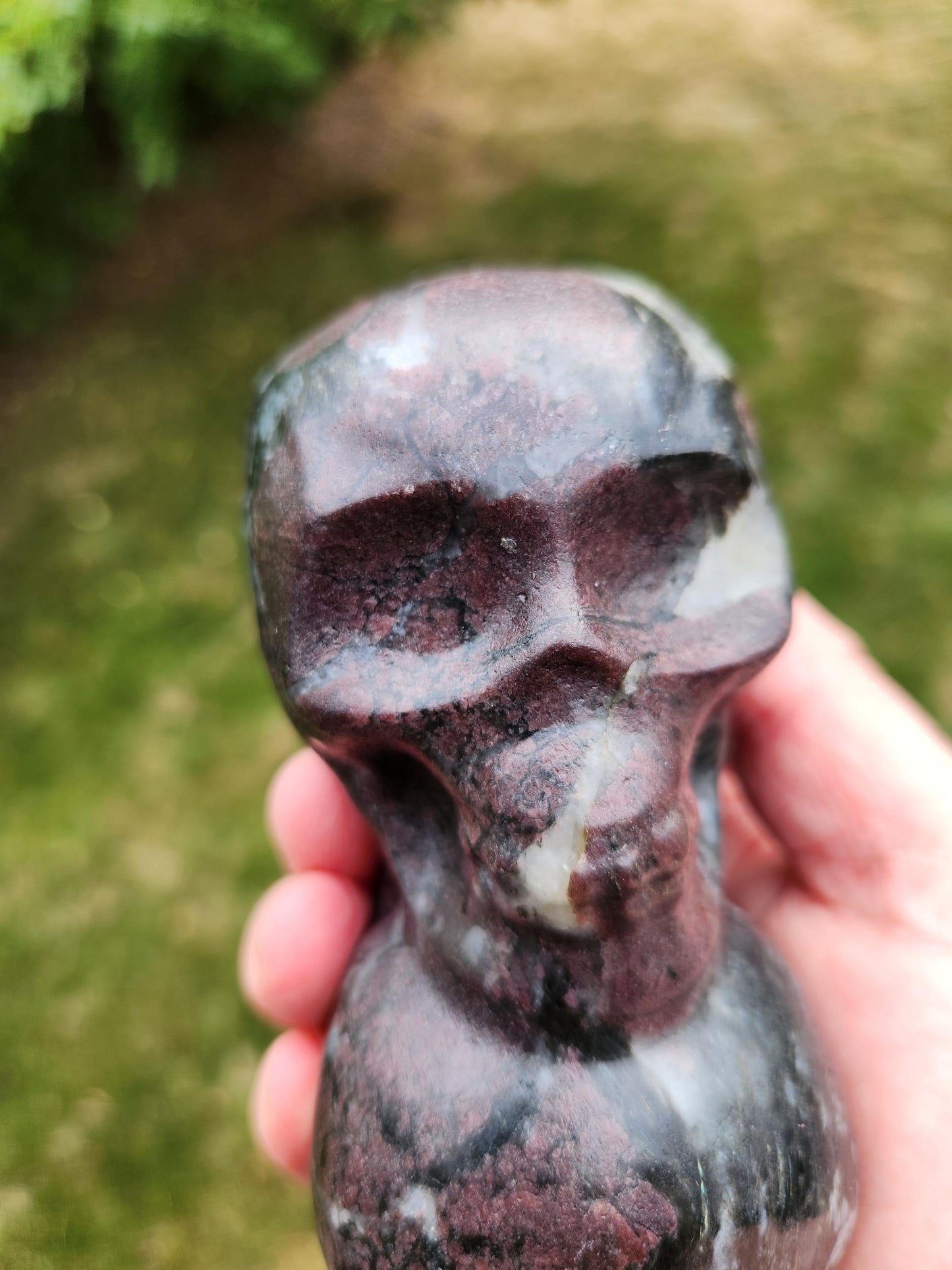 Double Skull in Garnet with Fireworks or Arfvedsonite Crystal Carving