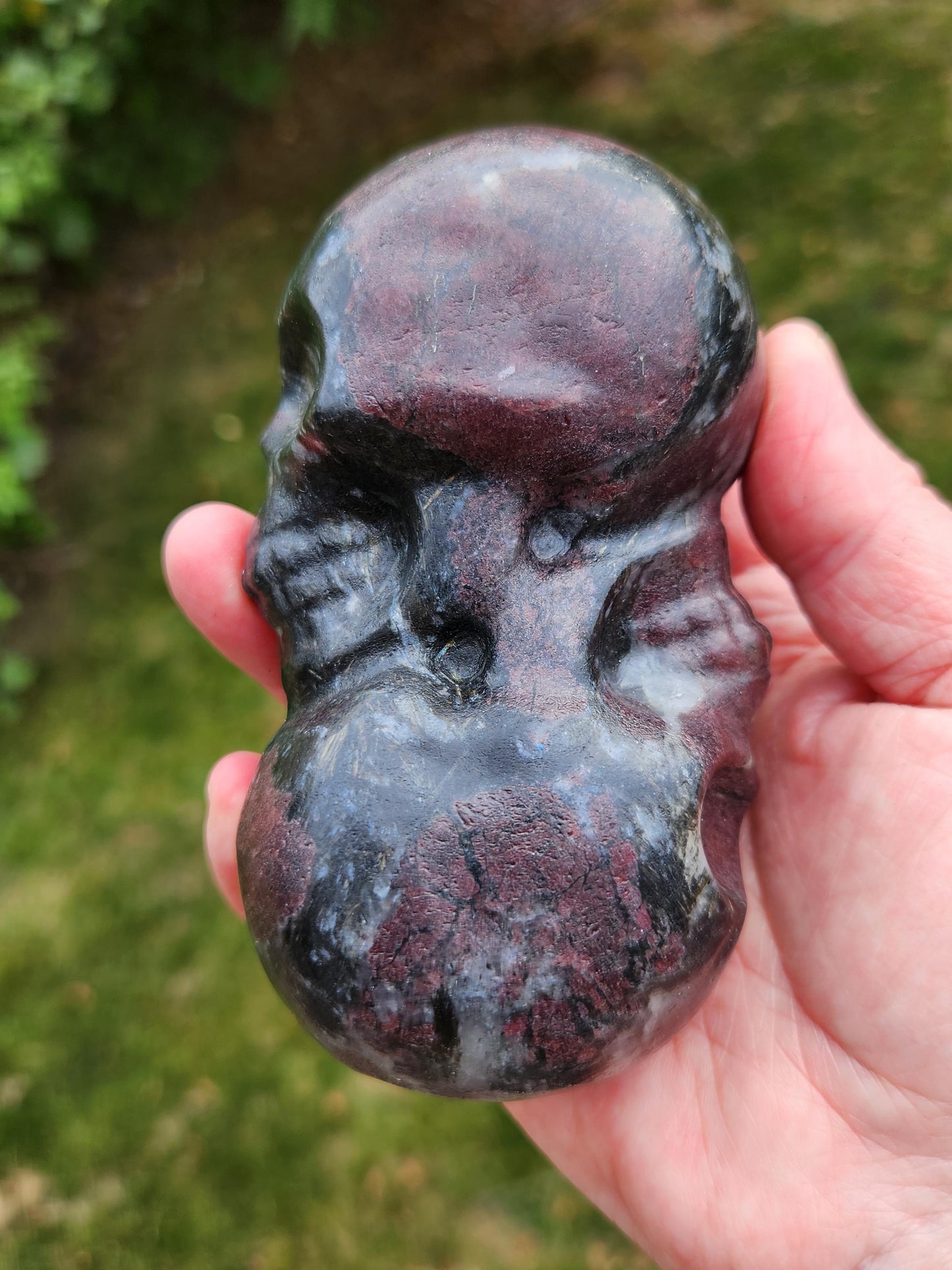 Double Skull in Garnet with Fireworks or Arfvedsonite Crystal Carving