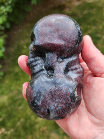 Double Skull in Garnet with Fireworks or Arfvedsonite Crystal Carving