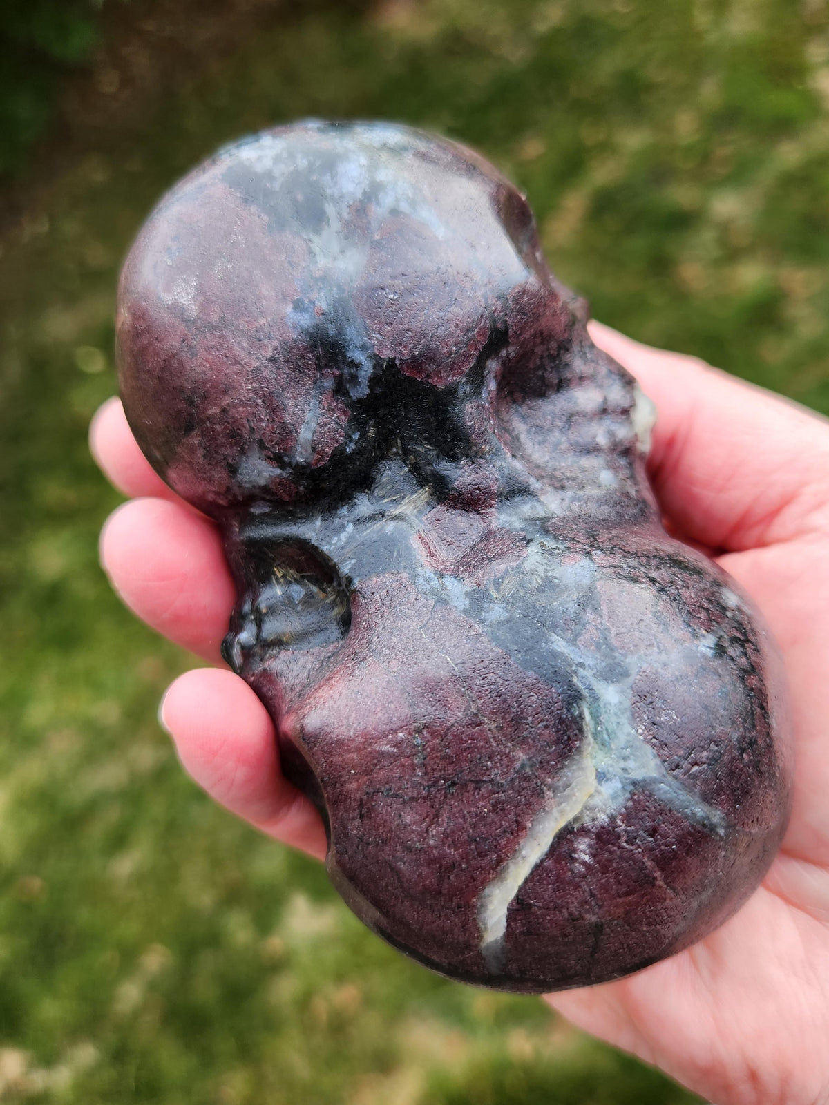 Double Skull in Garnet with Fireworks or Arfvedsonite Crystal Carving