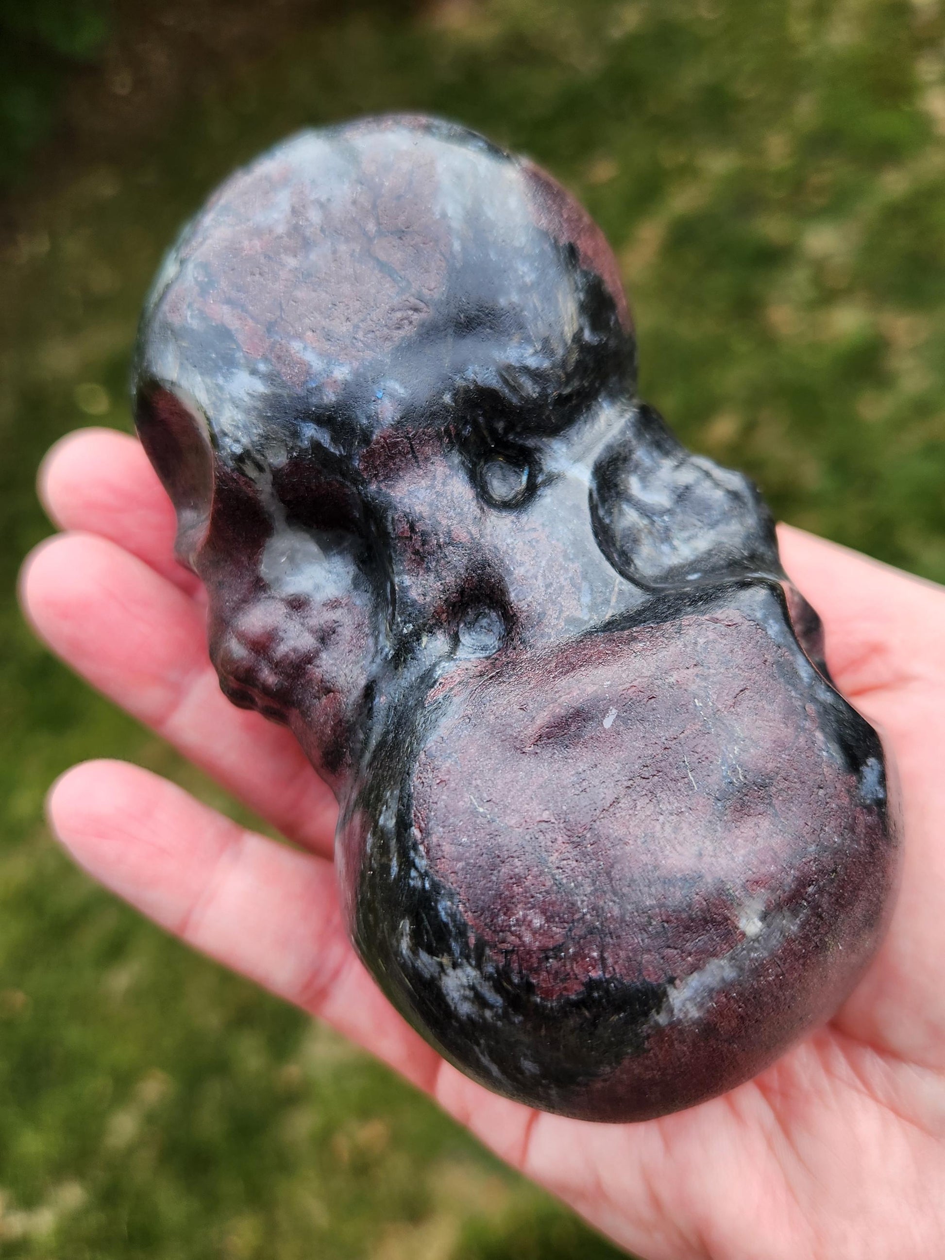 Double Skull in Garnet with Fireworks or Arfvedsonite Crystal Carving