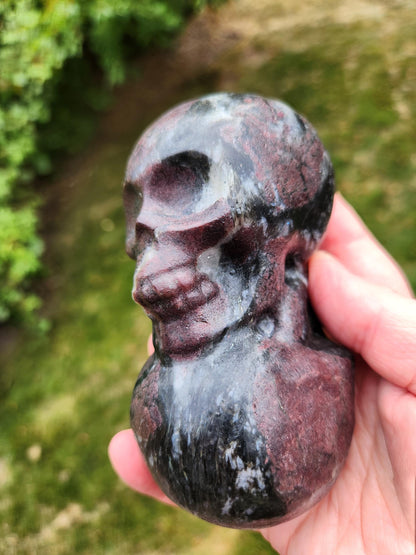 Double Skull in Garnet with Fireworks or Arfvedsonite Crystal Carving