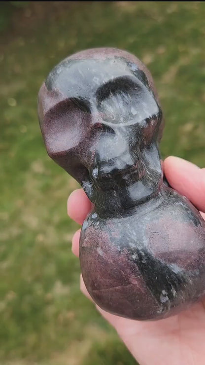 Double Skull in Garnet with Fireworks or Arfvedsonite Crystal Carving